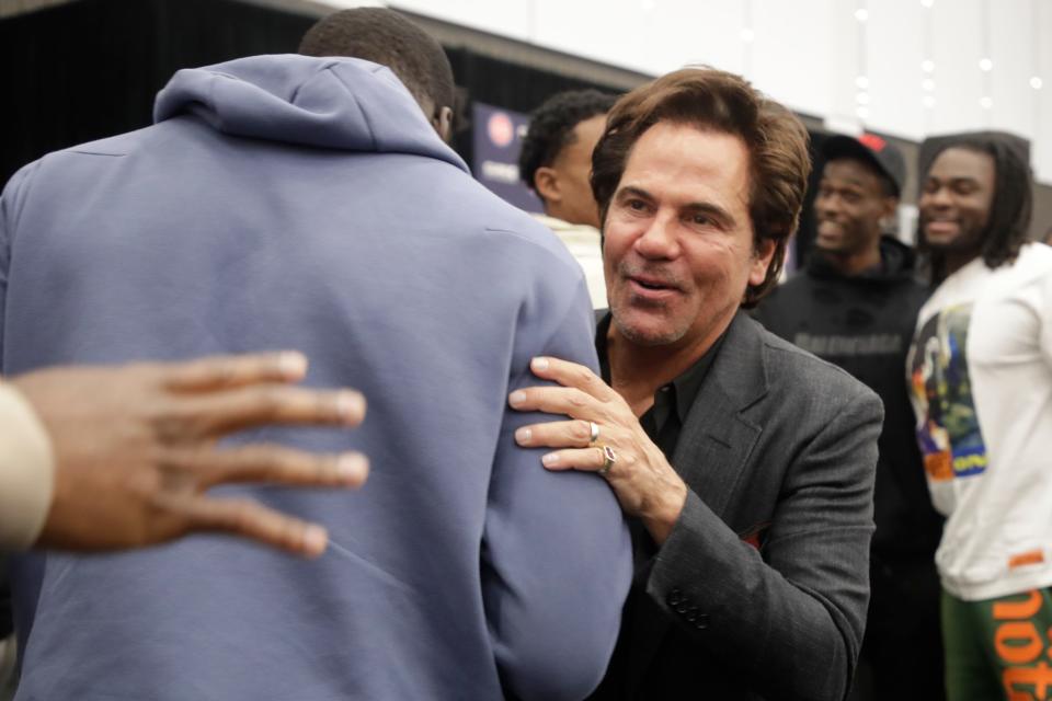 Detroit Pistons owner Tom Gores shakes hands with players at the conclusion of a news conference introducing new coach Monty Williams at the Henry Ford Detroit Pistons Performance Center, June 13, 2023.