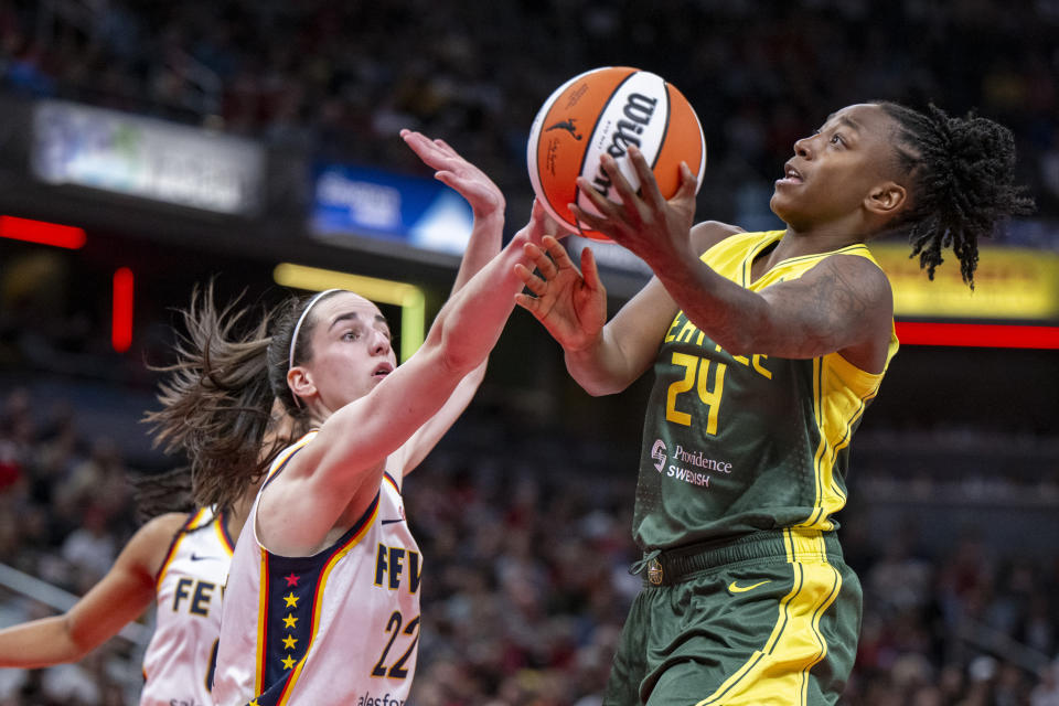 FILE - Seattle Storm guard Jewell Loyd (24) shoots against Indiana Fever guard Caitlin Clark (22) during the second half of a WNBA basketball game Thursday, May 30, 2024, in Indianapolis. (AP Photo/Doug McSchooler, File)