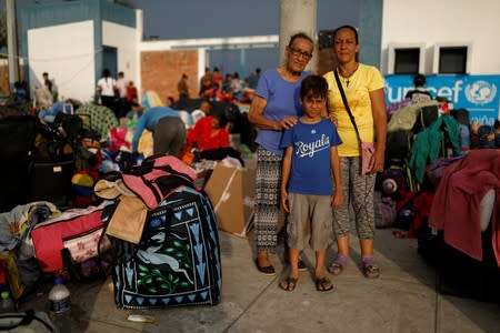 The Wider Image: Venezuelan mothers, children in tow, rush to migrate