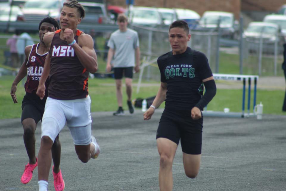 Mansfield Senior's Keontez Bradley (left) and Clear Fork's Joe Stupka (right) go at it here in the 200 meter final at the 90th Mehock Relays in Mansfield.