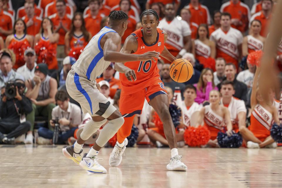 Auburn guard Chance Westry (10) dribbles against a Memphis defender during the first half of an NCAA college basketball game on Saturday, Dec. 10, 2022, in Atlanta, Ga. (AP Photo/Erik Rank)