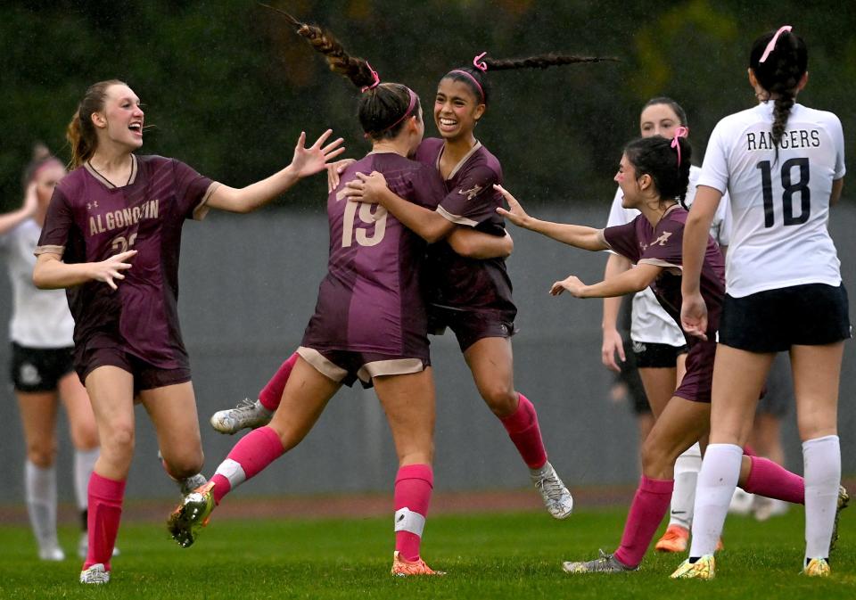 Algonquin's Kylie Tomasetti (19) is hugged by teammate Gabby Miranda after scoring in the second half against Westborough at Algonquin Regional High School in Northborough, Oct. 13, 2022.