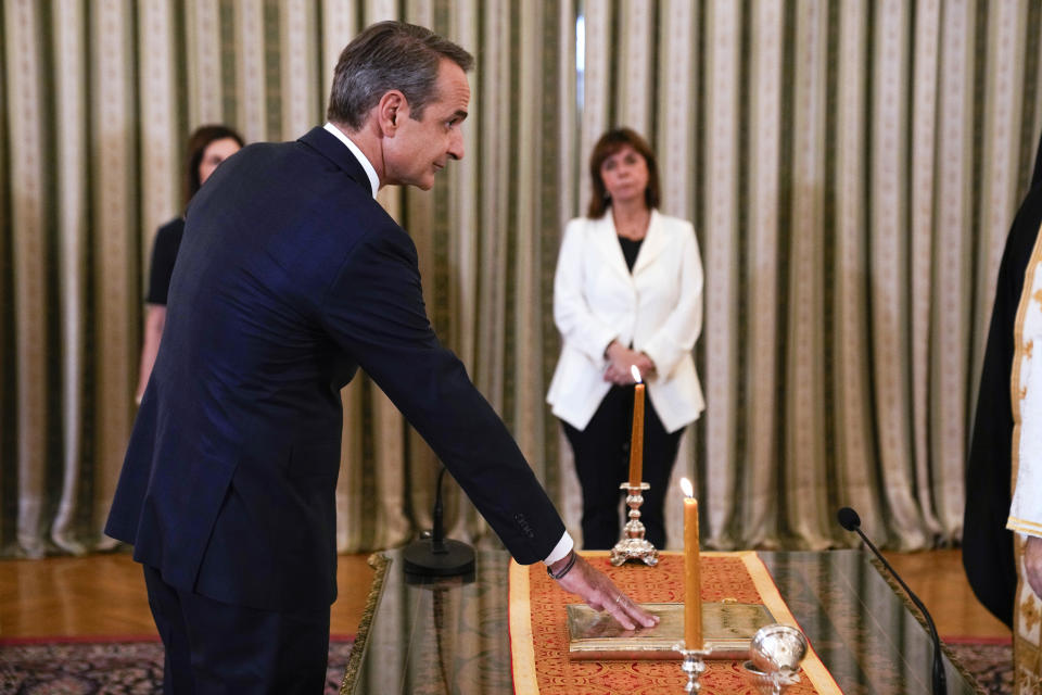 Greece's Prime Minister Kyriakos Mitsotakis takes the oath during a swearing in ceremony at the Presidential palace, in Athens, Greece, Monday, June 26, 2023. Greece's center-right leader Kyriakos Mitsotakis received the mandate to form a new government Monday after easily winning a second term with a record-high margin over the leftwing opposition, in an election that also ushered new far-right parties into Parliament. (AP Photo/Thanassis Stavrakis)