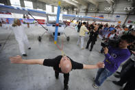 Stuntman Dong Changsheng, 50, pulls a 560 kg (1235 pounds) plane with his eyelids during a cultural festival in Changchun, Jilin province May 20, 2010. Dong, a martial art enthusiast for more than 30 years, pulled the plane about 5m (16 ft) during the performance, local media reported. REUTERS/Stringer