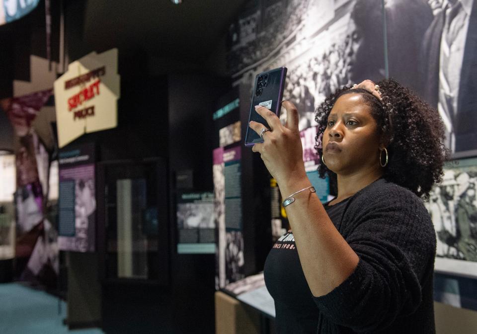 In town for business, McKenzie James of Columbia, Md., uses her lunch hour to visit the Mississippi Civil Rights Museum on Wednesday, Feb. 22, 2024. Knowing she won't get through it all, she takes photographs of exhibits to read later. The Civil Rights Museum has been named fourth on the list of the USA Today Best 10 history museums in the country.