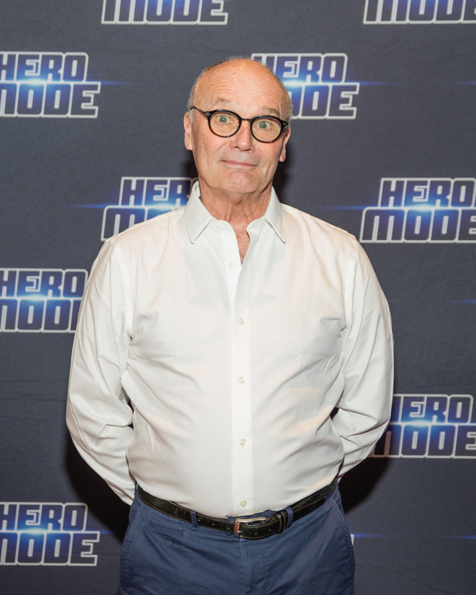 Creed Bratton in a white shirt and blue pants at a "Hero Mode" event