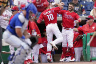 Philadelphia Phillies' J.T. Realmuto (10) celebrates with Bryce Harper, right, after hitting a solo home run during the third inning of a spring training baseball game against the Toronto Blue Jays, Wednesday, March 23, 2022, in Clearwater, Fla. (AP Photo/Lynne Sladky)