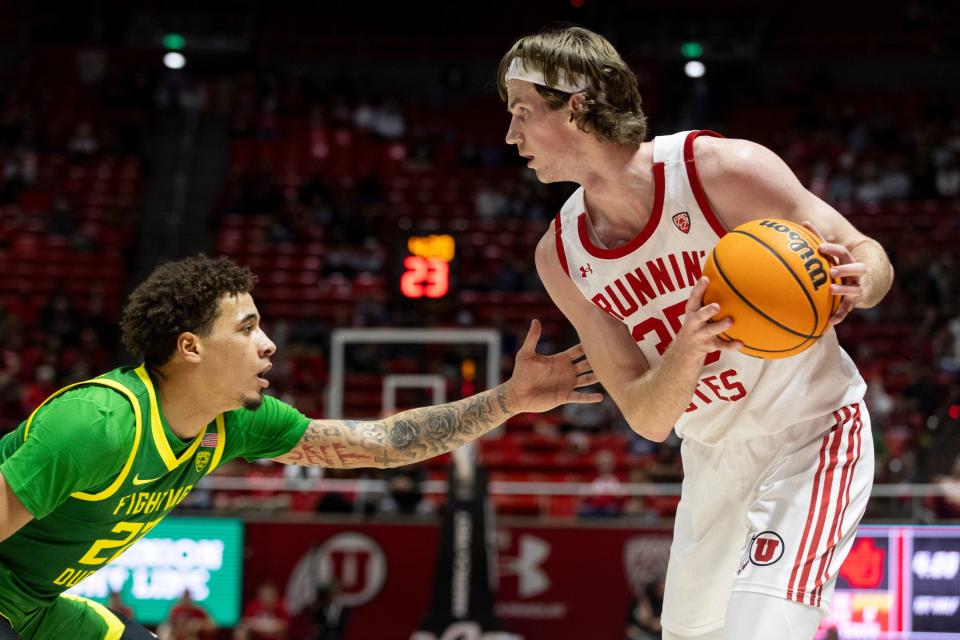 Utah Utes center, Branden Carlson (35) looks to pass the ball while blocked by Oregon Ducks guard, Jadrian Tracey (22) at the Huntsman Center in Salt Lake City on Jan. 21, 2024. The Utes won 80-77. | Marielle Scott, Deseret News