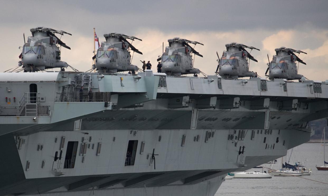 <span>Merlin helicopters on the flight deck of the HMS Queen Elizabeth.</span><span>Photograph: Andrew Matthews/PA</span>