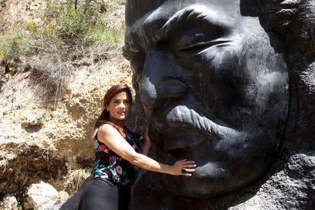 Actress Salma Hayek stands by a statue of late writer Khalil Gibran during a visit to promote her film "The Prophet" in Gibran's hometown of Bcharre, Lebanon April 26, 2015. REUTERS/Stringer