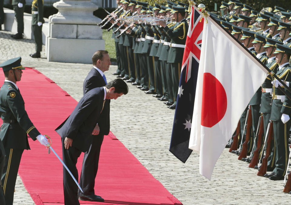 Australian Prime Minister Tony Abbott, center rear , reviews an honor guard during a welcome ceremony with Japanese Prime Minister Shinzo Abe, front, at Akasaka State Guest House in Tokyo Monday, April 7, 2014. Abbott is on a four-day official visit. (AP Photo/Koji Sasahara)