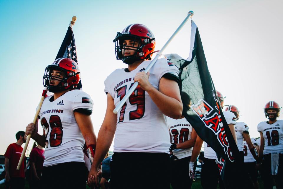 Football players for Southern Boone High School walk onto the field hand in hand with each other before playing in a game against the California Pintos on Sept. 9, 2022 at Southern Boone High School in Ashland. 