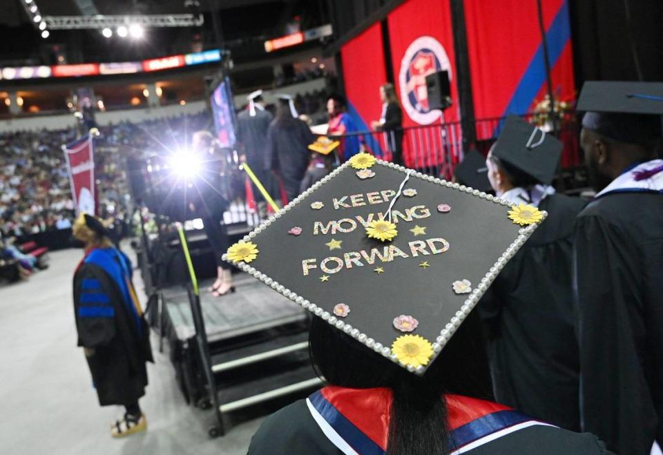 Students make their way to the stage during the College of Arts and Humanities commencement exercise for Fresno State Friday, May 20, 2022 in Fresno.