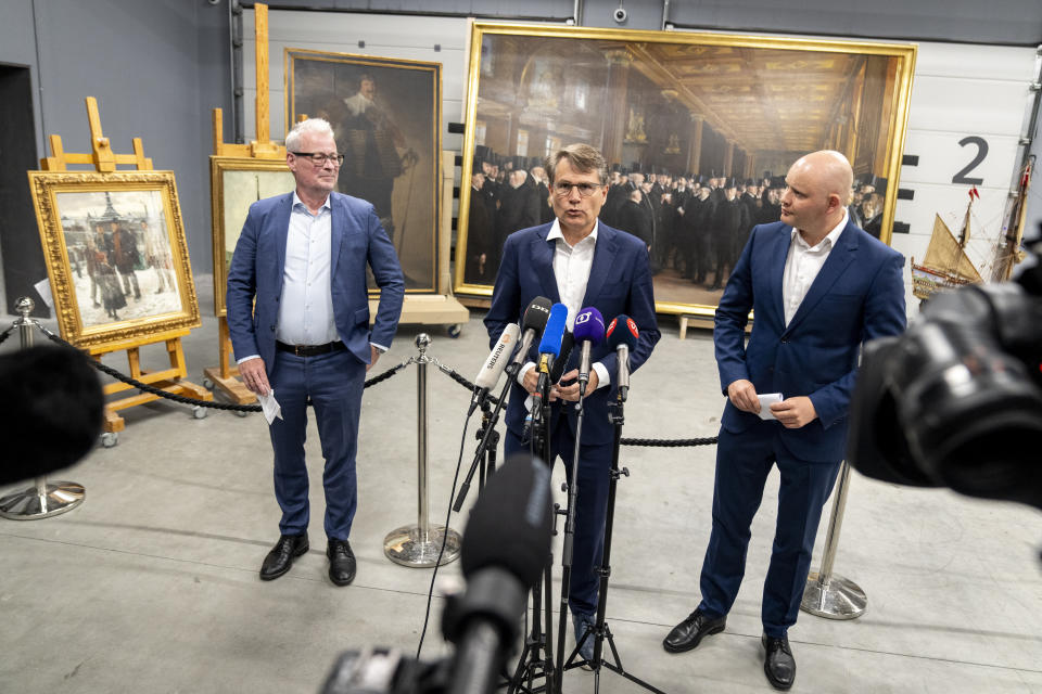 Minister of Culture Jakob Engel-Schmidt, right, CEO of Danish Business Brian Mikkelsen, center, and director of the National Museum Rane Willerslev speak to the press as they show artworks saved from Boersen during the fire, at the National Museum's warehouse in Vinge, Denmark, on Tuesday, June 4, 2024. Boersen, in Copenhagen, caught fire on April 16, 2024. More than 300 art objects were saved from the burning building. (Ida Marie Odgaard/Ritzau Scanpix via AP)