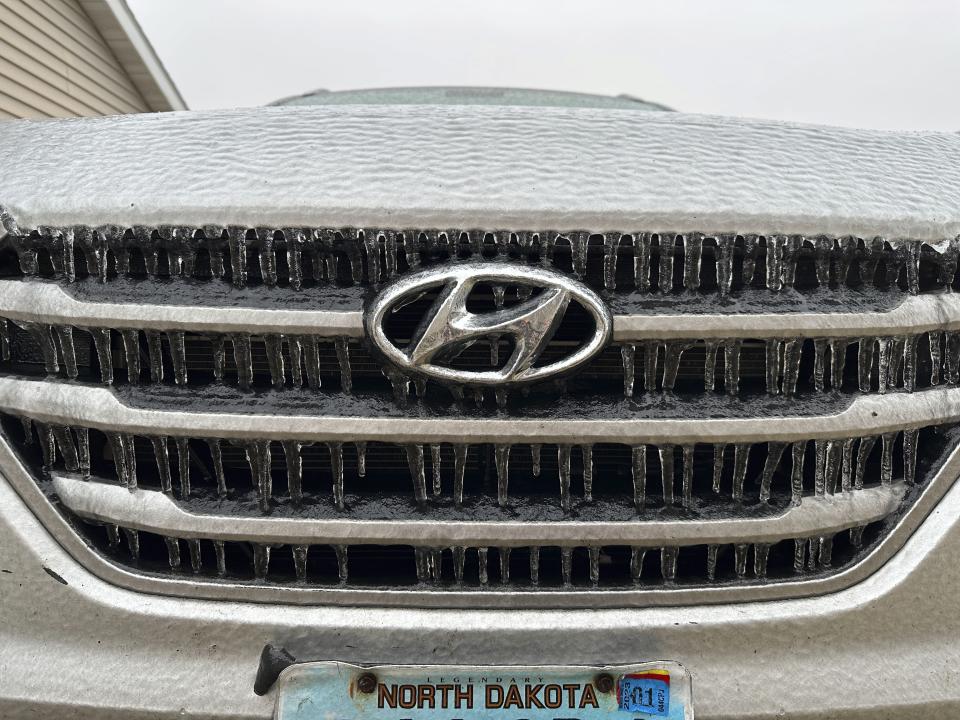 Ice coats a vehicle in Bismarck, N.D., on Tuesday, Dec. 26, 2023. An ice storm, part of a multistate storm in the Northern Plains, struck eastern North Dakota beginning Monday afternoon, Dec. 25, and moved westward, making highways slippery and impacting travel. (AP Photo/Jack Dura)