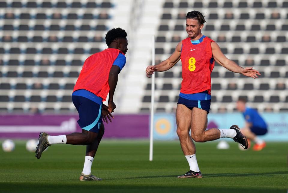 England's Jack Grealish and Bukayo Saka during a training session (PA)