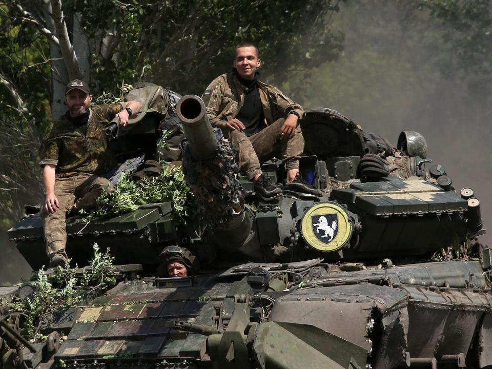 Ukrainian soldiers riding a tank