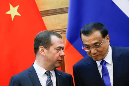 Chinese Premier Li Keqiang and Russian Prime Minister Dmitry Medvedev attend a signing ceremony at the Great Hall of the People in Beijing, China, November 1, 2017. REUTERS/Thomas Peter