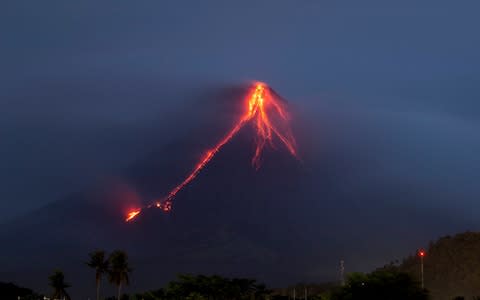 Lava cascades down the slopes of Mayon volcano, about 210 miles south-east of Manila, Philippines - Credit: AP