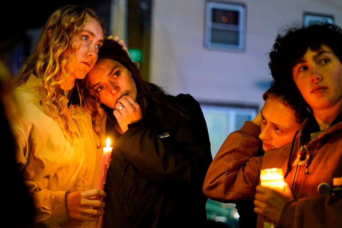 People linger after a vigil for the victims of Wednesday’s mass shootings, Sunday, Oct. 29, 2023 (The Associated Press)