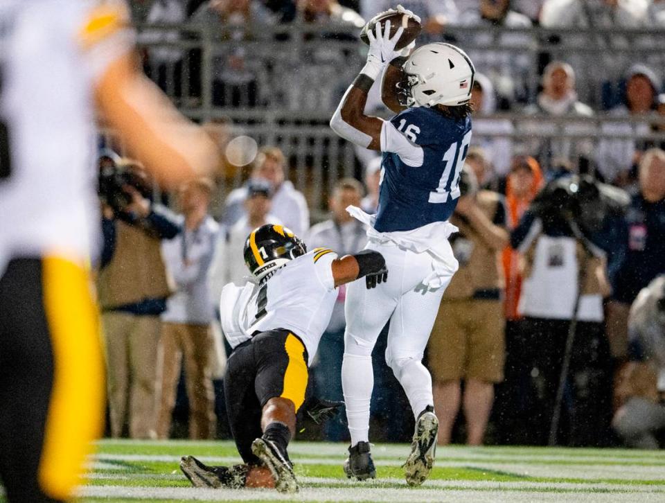 Penn State tight end Khalil Dinkins makes a catch for a touchdown around Iowa’s Xavier Nwankpa during the game on Saturday, Sept. 23, 2023.