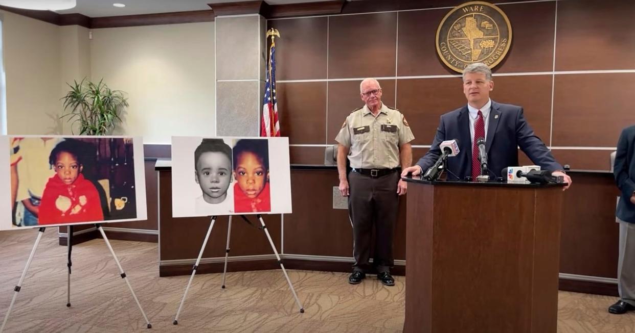 This screen grab taken from the Georgia Bureau of Investigation's livestream of the news conference shows Georgia Bureau of Investigation Agent Jason Seacrist, at podium, and Ware County Sheriff Carl James addressing reporters in Waycross, Ga., Monday, Nov. 13, 2023, to announce a break in an unsolved child death that stumped investigators for nearly 35 years. Authorities said they have identified a girl whose body was found encased in concrete in December 1988 as 5-year-old Kenyatta Odom. The girl's mother and a then-boyfriend have been charged with the child's murder and other crimes.