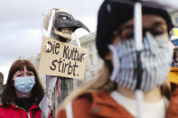 A woman holds a poster reading:'The culture dies' as she attends a protest of people working in the entertainment and event industry against the German government's economic policies to combat the spread of the coronavirus and COVID-19 disease and demand more support for their business, in Berlin, Germany, Wednesday, Oct. 28, 2020. (Photo/Markus Schreiber)