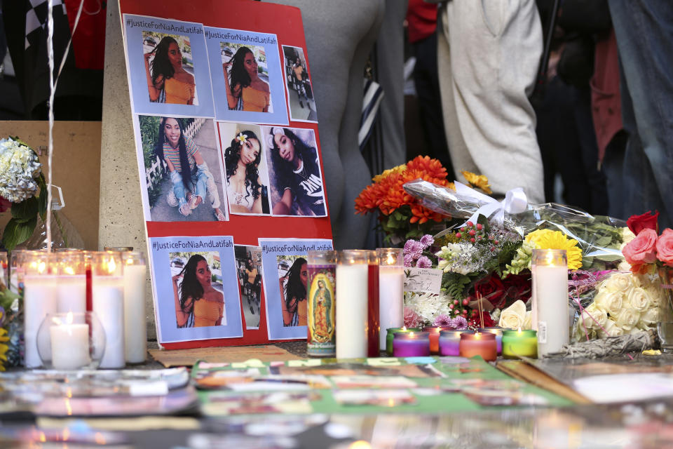 A memorial for 18-year-old Nia Wilson takes shape outside Bay Area Rapid Transit's MacArthur Station, Monday, July 23, 2018, a day after she was fatally stabbed on a platform at the station, in Oakland, Calif. (AP Photo/Lorin Eleni Gill)