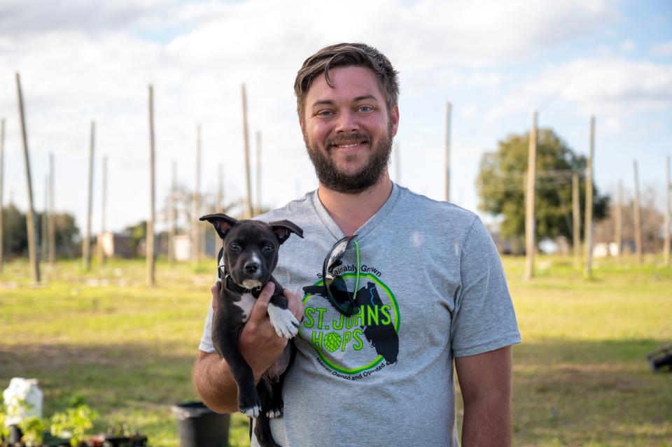 Rowan Sockol, with his new puppy, works at St. Johns Hops farm in Umatilla.