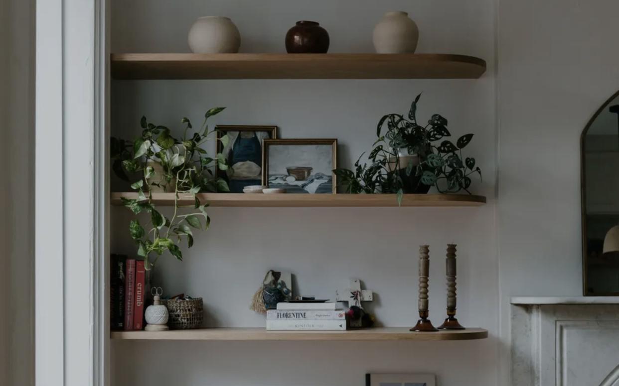  Wood floating shelves with rounded edge and styled with books and objects. 