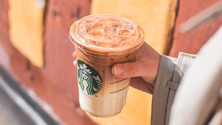 Woman holding Starbucks latte