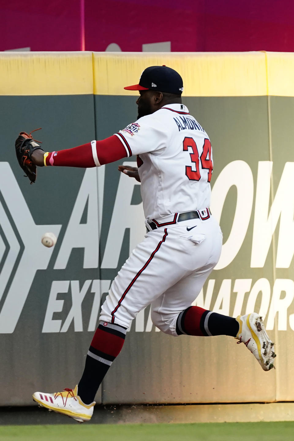 Atlanta Braves left fielder Abraham Almonte runs down a ball hit for a triple by Boston Red Sox's J.D. Martinez during the third inning of a baseball game Tuesday, June 15, 2021, in Atlanta. (AP Photo/John Bazemore)