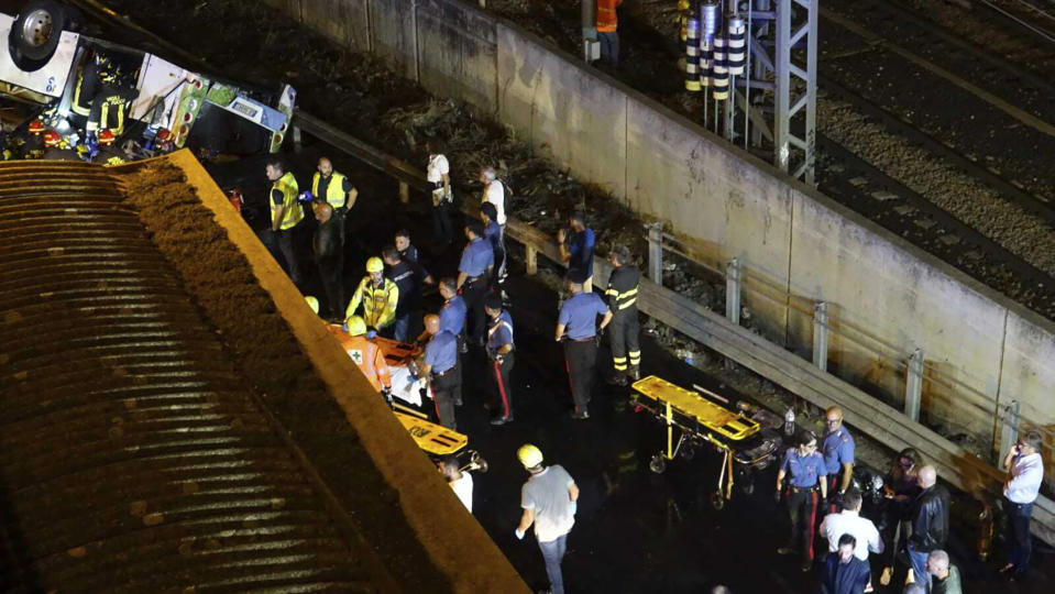 Emergency services work at the scene of a passenger bus accident near the city of Venice, Italy, that fell from an elevated road, late Tuesday, Oct. 3, 2023. Italian authorities say multiple people have been killed and others injured in the bus crash. The crash happened Tuesday when the bus fell from an elevated street in the Mestre borough on the mainland opposite the old city of Venice. (Slow Press/LiveMedia/LaPresse via AP)