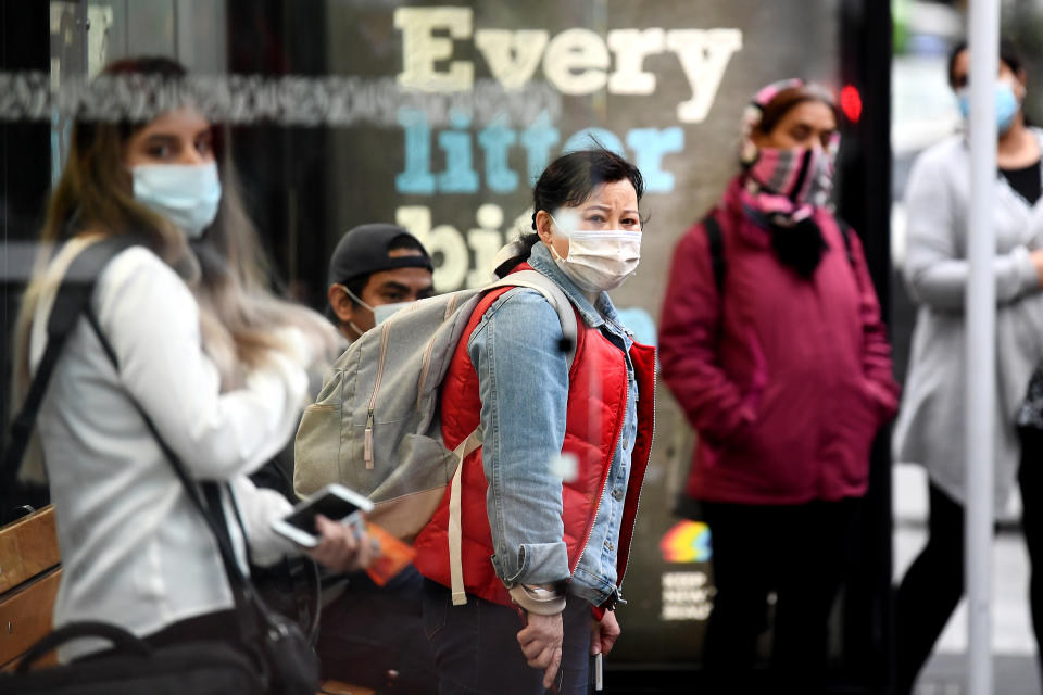 AUCKLAND, NEW ZEALAND - AUGUST 31: Members of the public wearing face masks wait for a bus on August 31, 2020 in Auckland, New Zealand. Face coverings are now compulsory for all New Zealanders over the age of 12 on public transport or planes under current Alert Level restrictions in place across the country. Auckland is currently at Alert Level 2.5 while the rest of New Zealand is at Alert Level 2. (Photo by Hannah Peters/Getty Images)