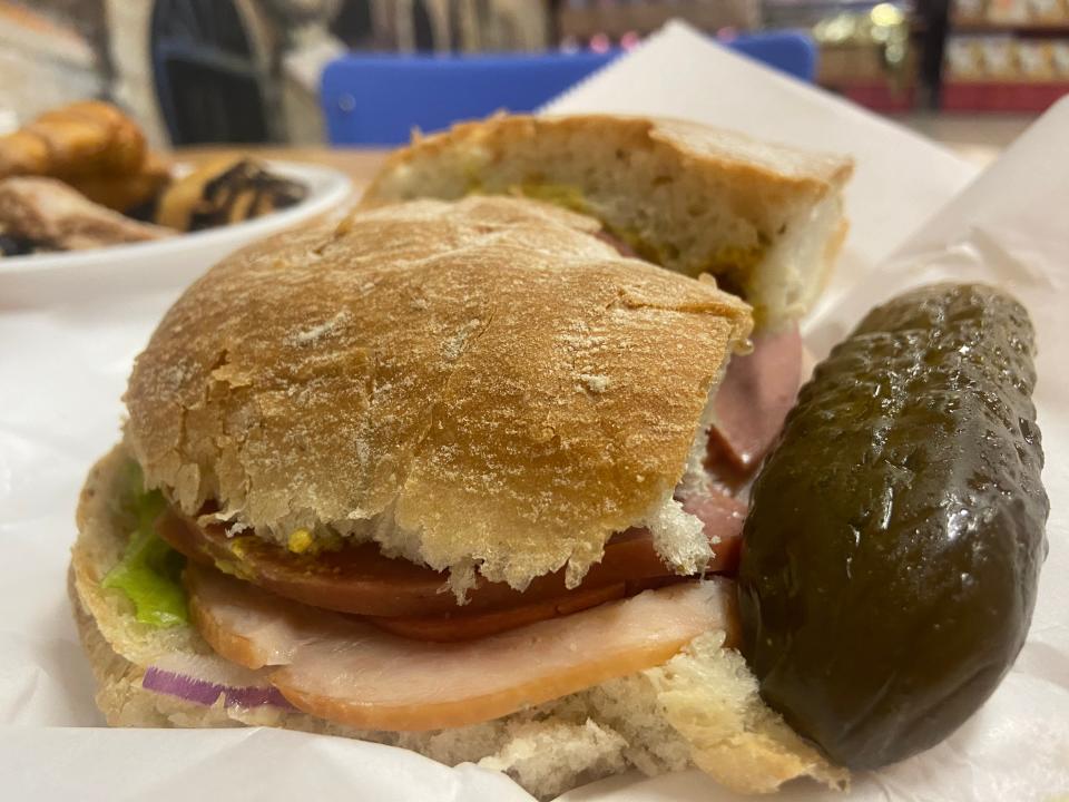 Salami and turkey make up the sandwich Zaidy's Feast with housemade focaccia bread and a spicy pickle at Maccabee's Kosher Deli in Des Moines, Oct. 19, 2023.