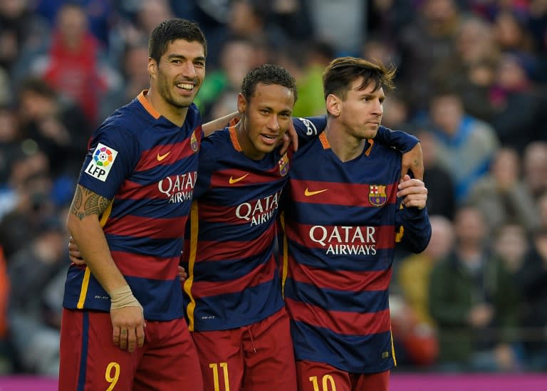 Barcelona's Brazilian forward Neymar (C) celebrates with Luis Suarez (L) and Lionel Messi after scoring their third goal during the Spanish league match vs Real Sociedad, in Barcelona on November 28, 2015