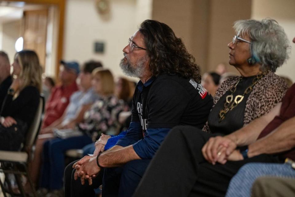Ilya Tarshansky, a survivor of Oct. 7 Hamas attack on Israel, watches his video presentation with audience on Thursday at the Folsom Community Center. His daughter was taken by Hamas miliants and held hostage for 54 days. His son was killed.