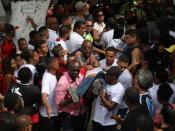 The uncle of teenage soccer player Samuel Thomas de Souza Rosa, who died in the fire that swept through Flamengo's training ground, is being helped during the funeral of his nephew, in Rio de Janeiro, Brazil February 11, 2019. REUTERS/Pilar Olivares