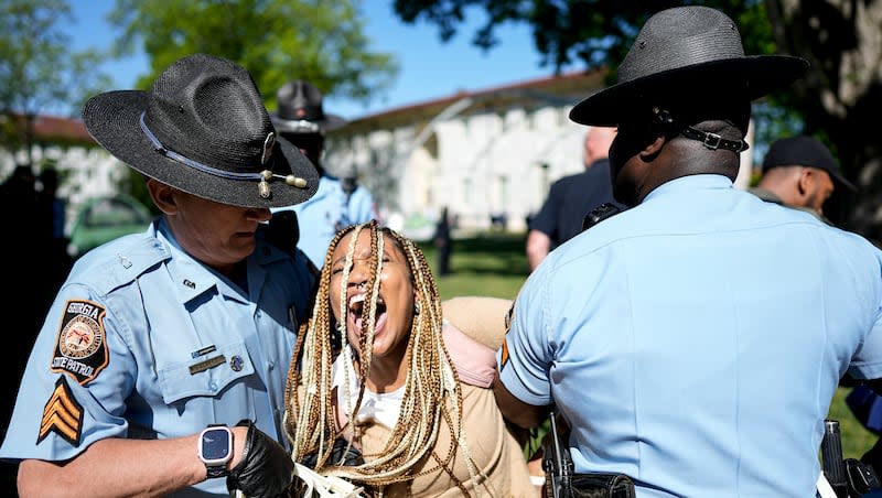 Georgia State Patrol officers detain a demonstrator on the campus of Emory University during a pro-Palestinian demonstration, Thursday, April 25, 2024, in Atlanta.