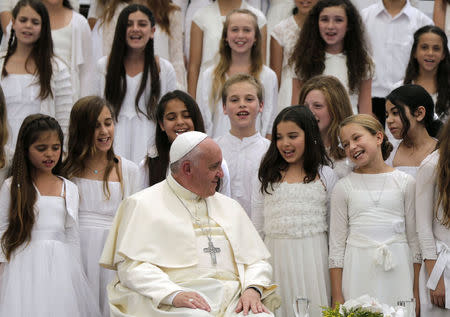 Pope Francis listens to a children's choir during a reception at the residence of Israel's President Shimon Peres in Jerusalem May 26, 2014. REUTERS/Tsafrir Abayov/Pool