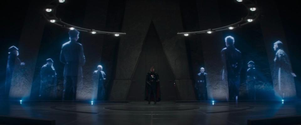 Moff Gideon stands in the middle of eight holograms during a Shadow Council meeting on The Mandalorian