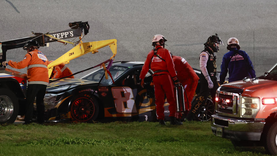 Kyle Busch, second from right, leaves his car to be taken to the infield care center after he crashed during the second of two qualifying auto races for the NASCAR Daytona 500 at Daytona International Speedway, Thursday, Feb. 16, 2023, in Daytona Beach, Fla. He was evaluated and released from the care center a short time later. (AP Photo/Mike Troxell)