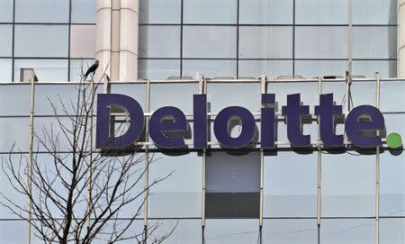 FILE PHOTO: The Deloitte Company logo is seen on a commercial tower at Gurgaon, on the outskirts of New Delhi August 9, 2012. REUTERS/Parivartan Sharma