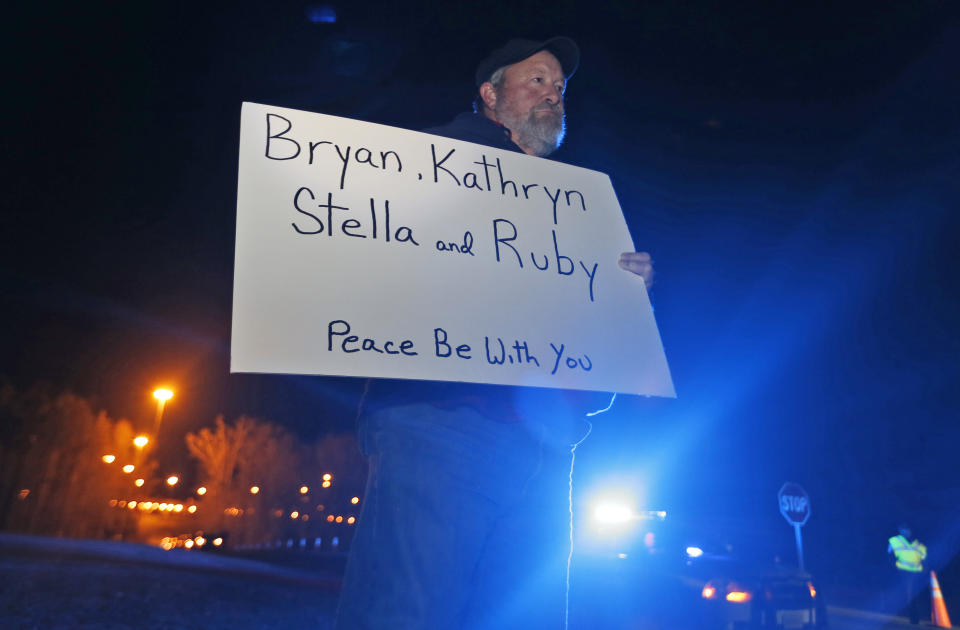 Staunton Va., resident, Chuck Troutman, holds a sign in remembrance of the Harvey family outside the Greensville Correctional Center in Jarratt, Va., Wednesday, Jan. 18, 2017. Troutman demonstrated in support of the execution of Ricky Gray who is scheduled to be executed for the murders of the Harvey family Wednesday at the Correctional Center. (AP Photo/Steve Helber)