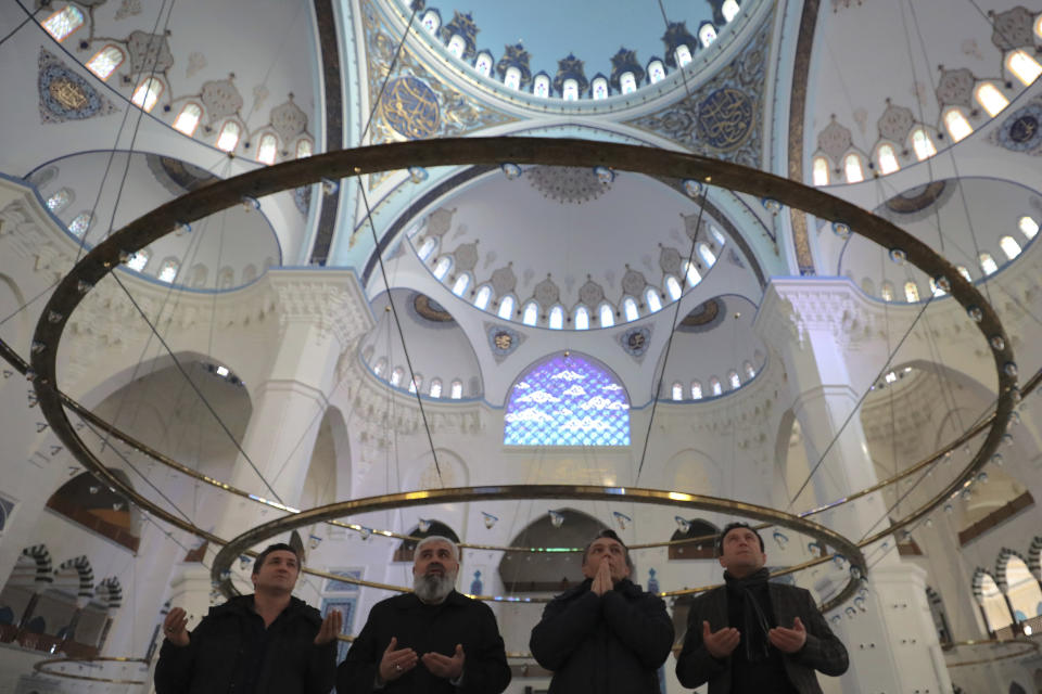 Men pray at the Camlica mosque in Istanbul, Sunday, March 31, 2019. Turkish citizens have begun casting votes in municipal elections for mayors, local assembly representatives and neighborhood or village administrators that are seen as a barometer of Erdogan's popularity amid a sharp economic downturn. (AP Photo/Emrah Gurel)