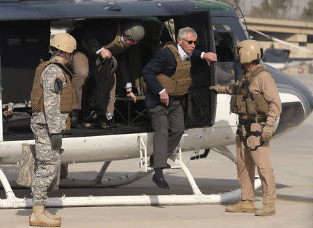 U.S. Defense Secretary Chuck Hagel wears body armor as he steps off a helicopter in Baghdad December 9, 2014. REUTERS/Mark Wilson/Pool