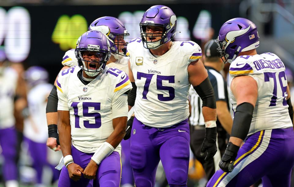 Joshua Dobbs #15 of the Minnesota Vikings celebrates after throwing a pass to Brandon Powell #4 of the Minnesota Vikings for the game-winning touchdown.