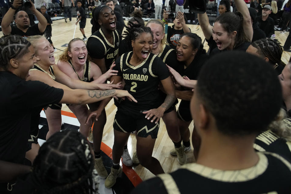 Colorado players celebrate after defeating LSU in an NCAA college basketball game Monday, Nov. 6, 2023, in Las Vegas. (AP Photo/John Locher)