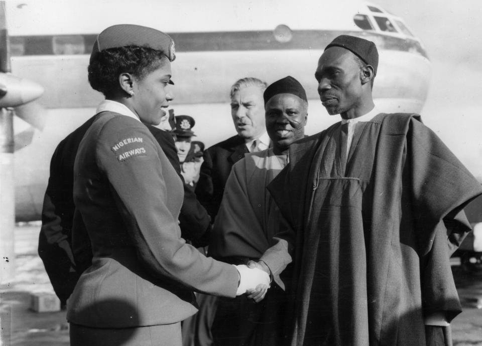 Nigerian Prime Minister Abubakar Tafawa Balewa greets stewardess Christina Twsela after the inaugural flight of Nigerian Airways in 1958.