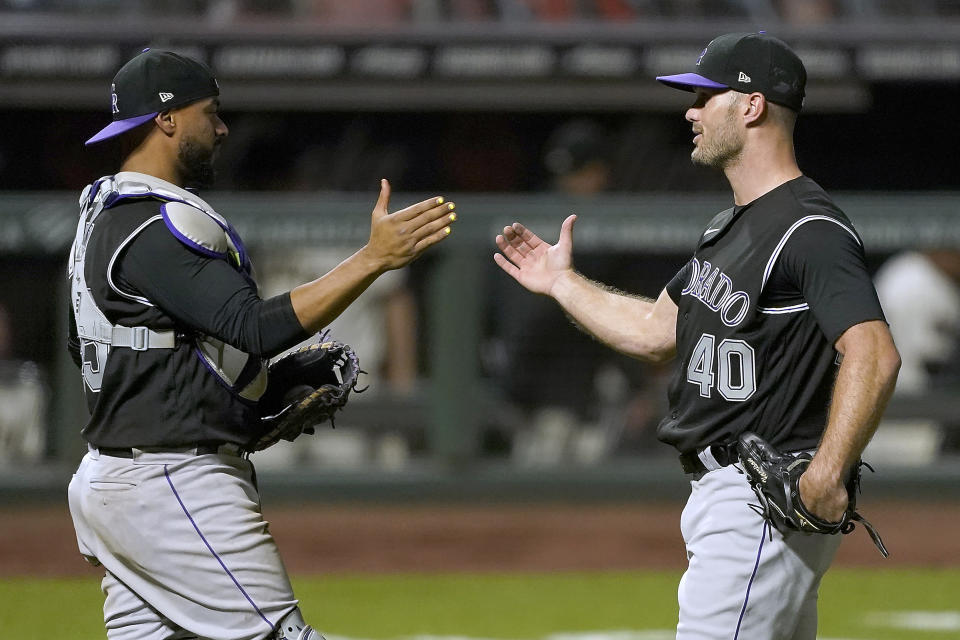 Colorado Rockies relief pitcher Tyler Kinley (40) is congratulated by catcher Elias Diaz after the final out of the ninth inning in a baseball game against the San Francisco Giants on Monday, Sept. 21, 2020, in San Francisco. Colorado won 7-2. (AP Photo/Tony Avelar)